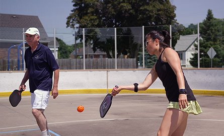 A couple playing pickleball outdoors